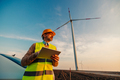 Engineer man looking and checking wind turbines at field - PhotoDune Item for Sale