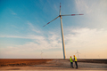 Engineers looking and checking wind turbines at field - PhotoDune Item for Sale
