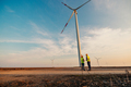 Two engineers looking and checking wind turbines - PhotoDune Item for Sale