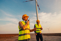 Male engineer using walkie talkie to checking system against wind turbine farm - PhotoDune Item for Sale