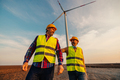Engineers working on the field at a wind turbine - PhotoDune Item for Sale
