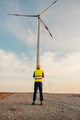 Engineer standing in front of turbines on a wind farm - PhotoDune Item for Sale