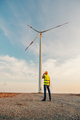 Engineer standing by turbines on a wind farm - PhotoDune Item for Sale