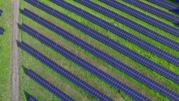 Aerial View of Solar Panels Stand in a Row in the Fields