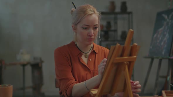 Gifted Woman Painter Creating Oil Painting on Easel