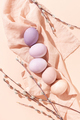 Colorful pastel Easter eggs and willow twigs on linen napkin on peach background. - PhotoDune Item for Sale