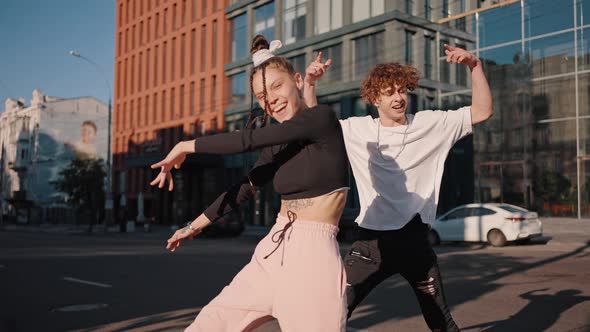 Couple of Young Dancers Performs Together on City Road