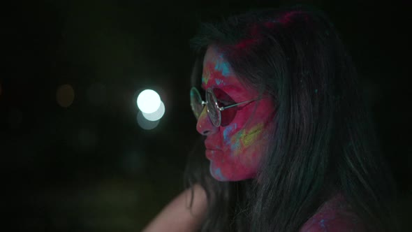 Dancing Young Indian Woman with Dry Color Powder Holi Exploding Around Her
