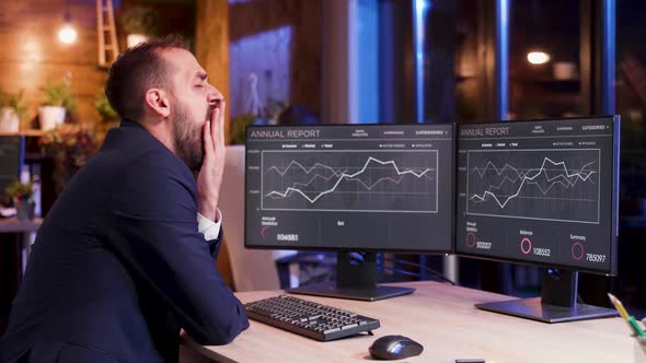 Tired Businessman in Suit Working During Night Hours at the Office