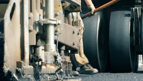 Wheels of an Asphalt-placing Vehicles in a Front View. Road Construction Process.