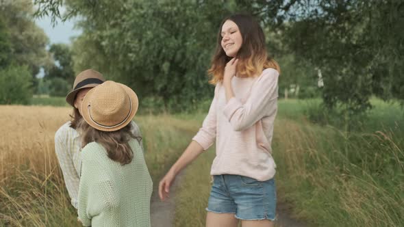 Family Mother and Daughters Walking Together Along Country Road