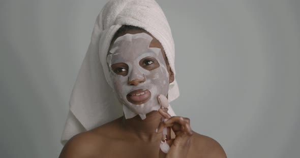 Black Girl Doing Facial Massage with a Roller