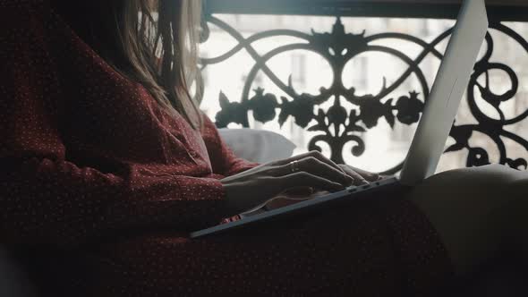 Cinematic Close-up on Happy Beautiful Businesswoman Using Laptop on Cozy French Balcony Bed on