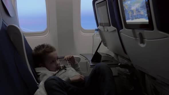 Child Watching Cartoon on Smartphone in Airplane