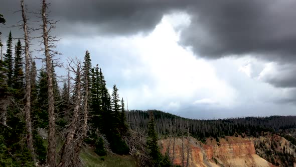 Stormy clouds and distant rain above a red cliff george in the high desert mountains