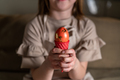girl holding an Easter egg in a colored ice cream cone - PhotoDune Item for Sale