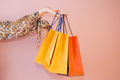 a girl holds shopping bags on a colored background - PhotoDune Item for Sale