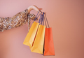 a girl holds shopping bags on a colored background - PhotoDune Item for Sale