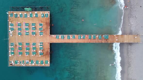 Pier with Sunbeds and Umbrellas