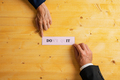 Businesspeople holding a pink paper with a Dont quit sign fading into a Do it message - PhotoDune Item for Sale