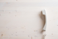 Simple white landline telephone handset placed on plain wooden background - PhotoDune Item for Sale