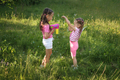 Preschool girls are having fun playing and blowing soap bubbles from a gun. - PhotoDune Item for Sale