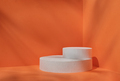 Minimal stage for a modern product display on a white podium cilindre on an orange background. - PhotoDune Item for Sale