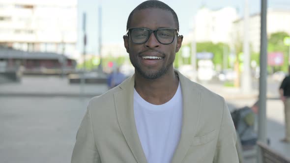 Portrait of African Man Smiling at Camera Outdoor