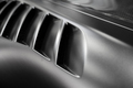 detail of black sport car with dark metal hood and air flow intake ornament - PhotoDune Item for Sale