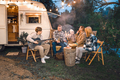 Family trailer travel.Children,brother sister,mom dad playing guitar,singing song at fire.Evening  - PhotoDune Item for Sale