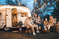 Family trailer travel.Children,brother sister,mom dad playing guitar,singing song at fire.Evening  - PhotoDune Item for Sale