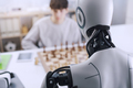 Chess challenge: boy and robot face-off - PhotoDune Item for Sale
