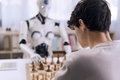 Intense competition: boy vs. robot chess match - PhotoDune Item for Sale