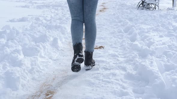 Woman Walk on the White Snow in Park