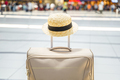Straw hat on big suitcase, bag in airport terminal. Waiting for boarding to flight. Family  - PhotoDune Item for Sale