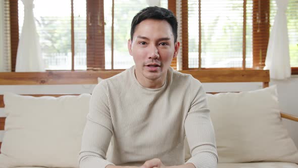 Happy young freelance asia man looking at camera smiling and cheerful relax.