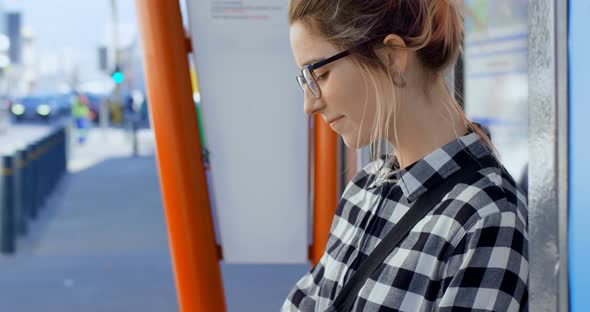 Woman sitting on bus stop 4k