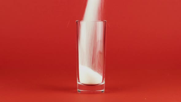 Pour Sugar Highball Glass Shot Thick Bottom Red Contrasting Background. Concept