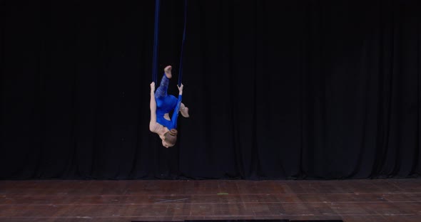 Teen Gymnast is Holding Onto the Strings and Spinning in the Air Gymnastics