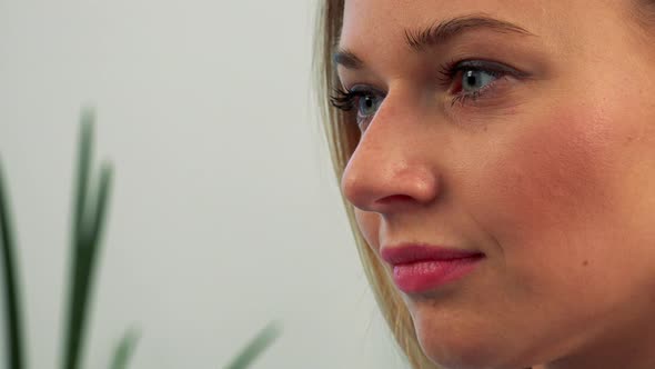 The Profile of a Young, Beautiful Female Face While She Works on a Computer - Closeup