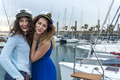 model women standing and posing on a sailboat while kissing to camera - PhotoDune Item for Sale