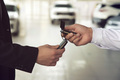 Car salesman gives the keys to the customers who signed the purchase contract - PhotoDune Item for Sale