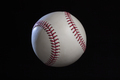 Baseball with dramatic lighting isolated on a black background - PhotoDune Item for Sale