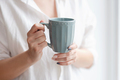 Closeup of female hands with a mug of beverage.  - PhotoDune Item for Sale