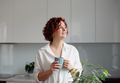 Portrait of joyful woman enjoying a cup of coffee at home.  - PhotoDune Item for Sale