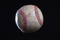 Old rough baseball with dramatic lighting isolated on a black background - PhotoDune Item for Sale