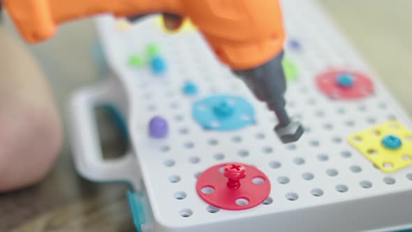 Child Playing with Toy Screwdriver Screwing Nuts and Bolts Learning Use