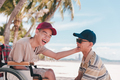 Outdoor activity travel by wheelchair with diverse family. - PhotoDune Item for Sale