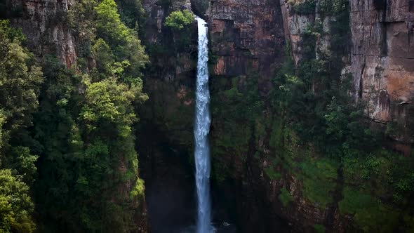 Aerial drone shot of a steep mountain pillar formation in Drakensberg, South Africa