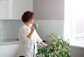 Portrait young woman enjoying a cup of coffee at home. pretty girl drinking hot tea - PhotoDune Item for Sale